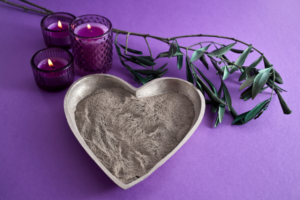 A silver bowl shaped like a heart filled with ash